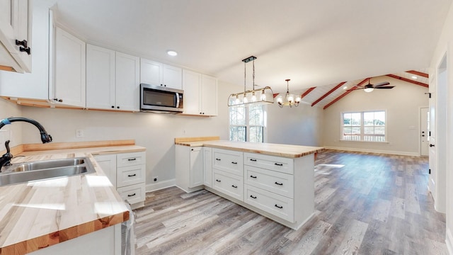 9716 Campbellsville Rd, Pulaski, TN 38478 - kitchen featuring stainless steel microwave, a sink, light wood-style floors, open floor plan, and recessed lighting