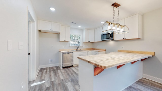 9716 Campbellsville Rd, Pulaski, TN 38478 - kitchen with stainless steel appliances, light wood finished floors, baseboards, white cabinetry, and recessed lighting