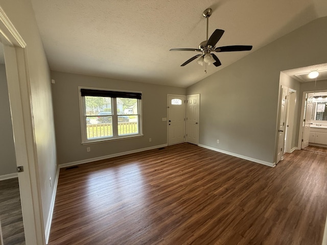 4725 Greystone St, Antioch, TN 37013 - unfurnished living room with vaulted ceiling, dark wood-style floors, ceiling fan, baseboards, and a textured ceiling