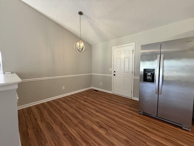 4725 Greystone St, Antioch, TN 37013 - unfurnished dining area with dark wood finished floors, vaulted ceiling, a chandelier, baseboards, and a textured ceiling