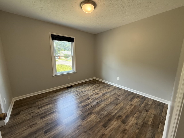 4725 Greystone St, Antioch, TN 37013 - empty room with dark wood finished floors, a textured ceiling, and baseboards