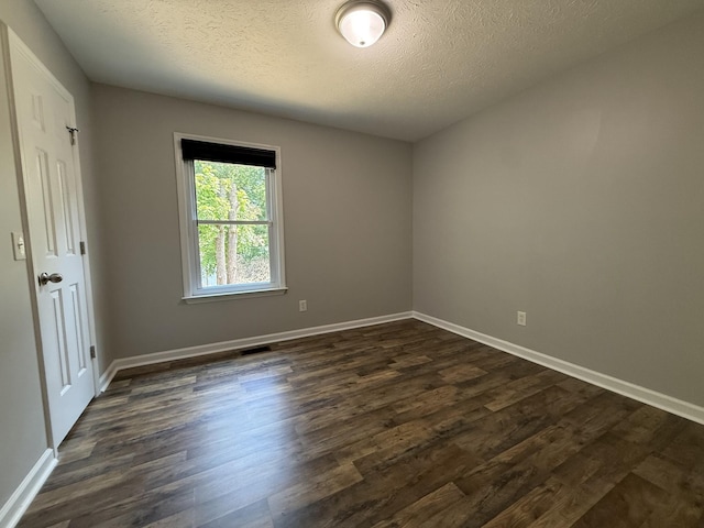 4725 Greystone St, Antioch, TN 37013 - empty room featuring dark wood-type flooring, a textured ceiling, and baseboards