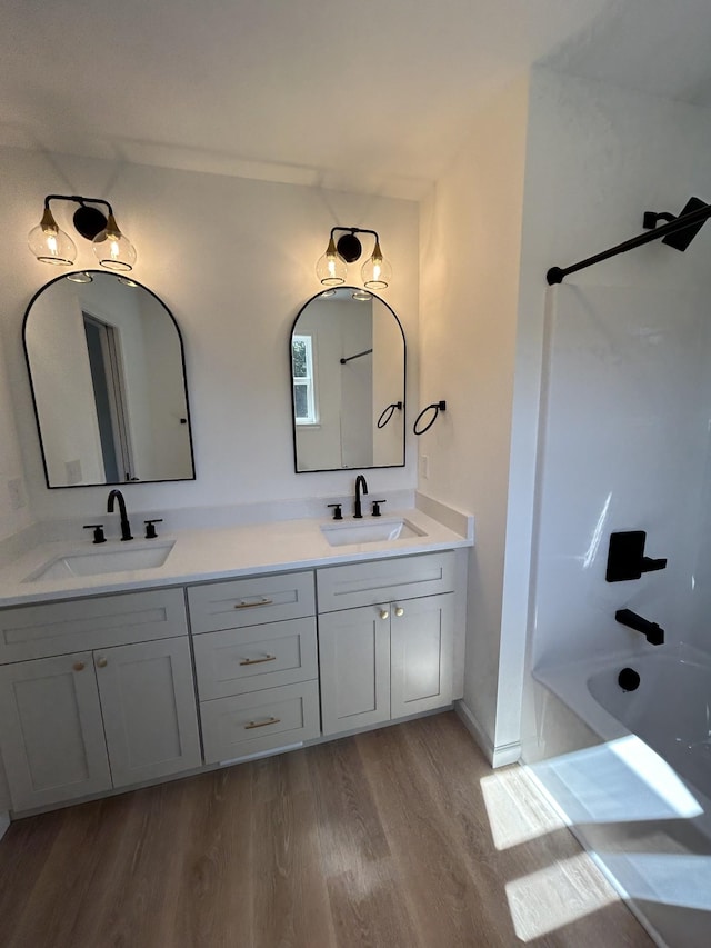9710 Campbellsville Rd, Pulaski, TN 38478 - full bathroom featuring wood finished floors, double vanity, and  shower combination