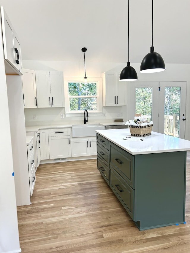 9710 Campbellsville Rd, Pulaski, TN 38478 - kitchen featuring a sink, white cabinets, healthy amount of natural light, and light wood finished floors
