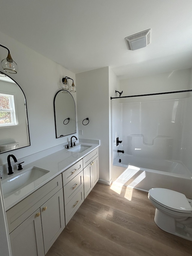9710 Campbellsville Rd, Pulaski, TN 38478 - full bath featuring toilet, washtub / shower combination, double vanity, and wood finished floors