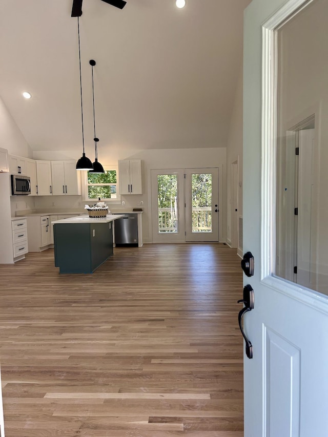 9710 Campbellsville Rd, Pulaski, TN 38478 - kitchen featuring stainless steel appliances, vaulted ceiling, white cabinetry, light wood-style floors, and a ceiling fan