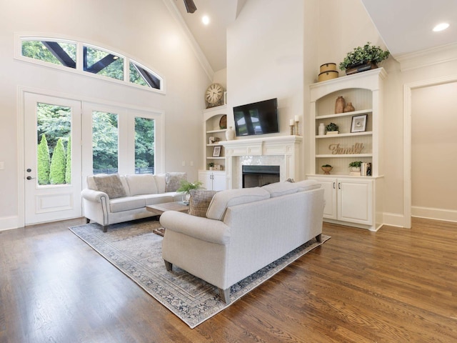5007 Buds Farm Ln, Franklin, TN 37064 - living area featuring a fireplace, high vaulted ceiling, baseboards, crown molding, and wood finished floors