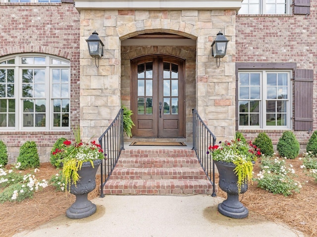 5007 Buds Farm Ln, Franklin, TN 37064 - view of exterior entry featuring french doors, stone siding, and brick siding