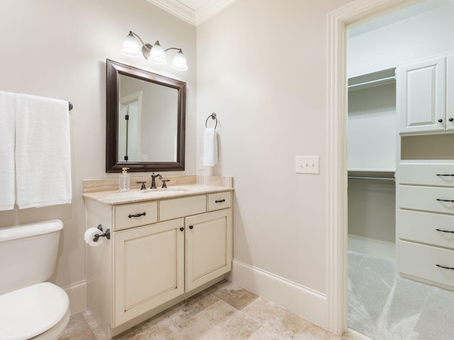 5007 Buds Farm Ln, Franklin, TN 37064 - bathroom featuring vanity, ornamental molding, toilet, baseboards, and a walk in closet