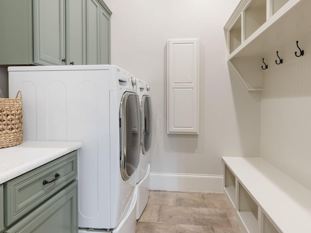5007 Buds Farm Ln, Franklin, TN 37064 - washroom featuring washing machine and dryer, cabinet space, baseboards, and stone finish flooring