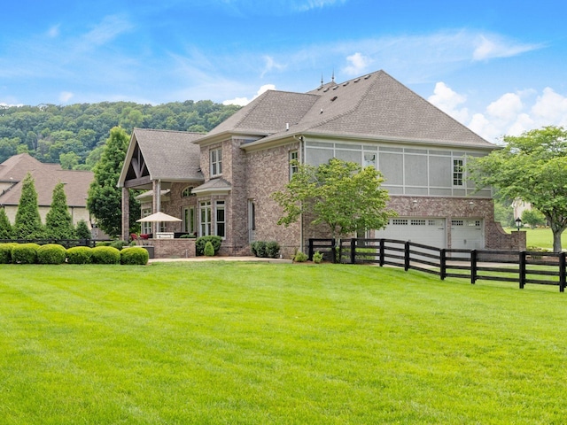 5007 Buds Farm Ln, Franklin, TN 37064 - back of house featuring a garage, brick siding, and roof with shingles