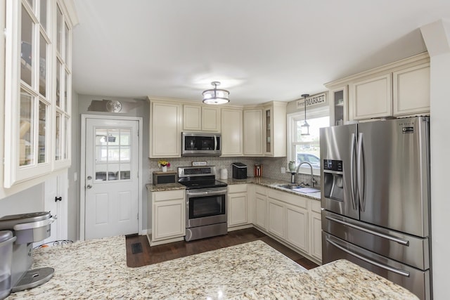 102 Ryburn Dr, Old Hickory, TN 37138 - kitchen with stainless steel appliances, a sink, cream cabinets, light stone countertops, and backsplash