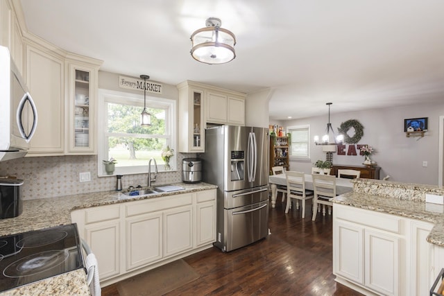 102 Ryburn Dr, Old Hickory, TN 37138 - kitchen featuring a sink, stainless steel appliances, decorative backsplash, and cream cabinets