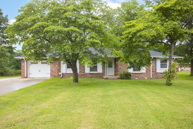 102 Ryburn Dr, Old Hickory, TN 37138 - view of property hidden behind natural elements with driveway, an attached garage, a front lawn, and brick siding