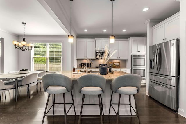 23 Hope Ct, Mount Juliet, TN 37122 - kitchen with stainless steel appliances, ornamental molding, a chandelier, light stone countertops, and recessed lighting