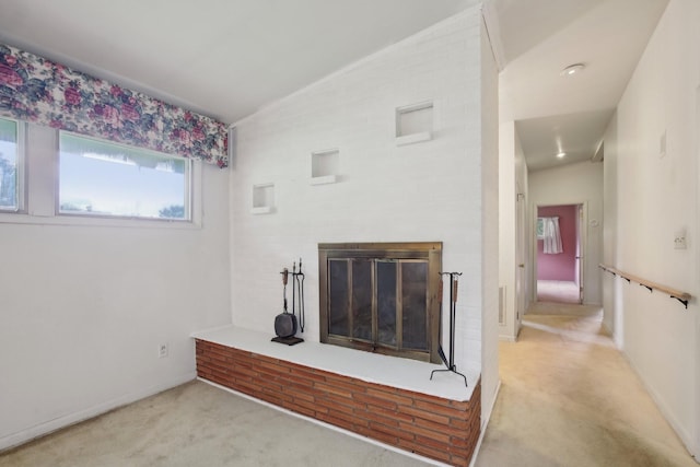 929 Deervale Dr, Nashville, TN 37217 - unfurnished living room with carpet flooring, lofted ceiling, a brick fireplace, and baseboards