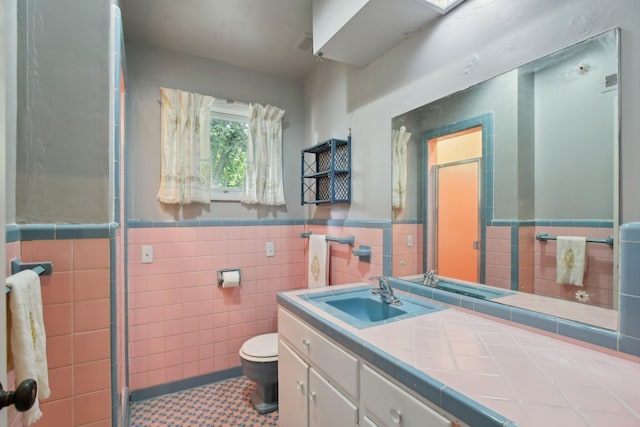 929 Deervale Dr, Nashville, TN 37217 - full bath with tile walls, a stall shower, vanity, toilet, and wainscoting