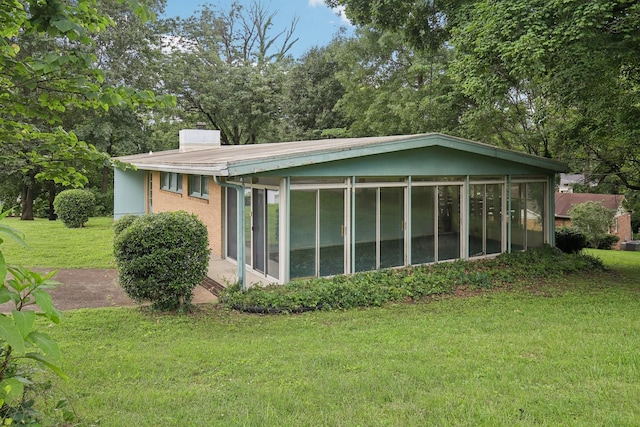 929 Deervale Dr, Nashville, TN 37217 - back of house with a sunroom, a lawn, and a chimney