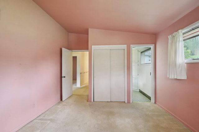 929 Deervale Dr, Nashville, TN 37217 - unfurnished bedroom with light carpet, a closet, vaulted ceiling, and baseboards