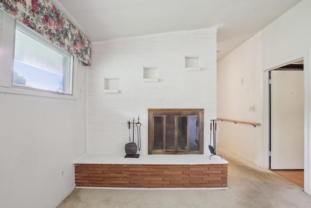929 Deervale Dr, Nashville, TN 37217 - unfurnished living room featuring a fireplace, vaulted ceiling, and carpet floors