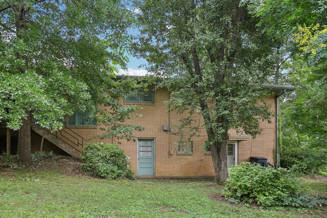 929 Deervale Dr, Nashville, TN 37217 - rear view of house featuring brick siding, a yard, and stairs