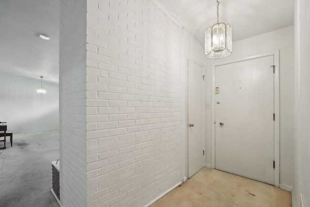929 Deervale Dr, Nashville, TN 37217 - entrance foyer featuring a chandelier, light colored carpet, and brick wall