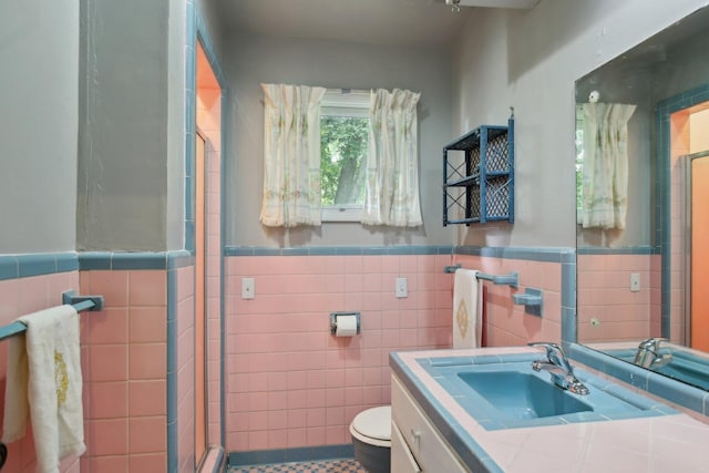 929 Deervale Dr, Nashville, TN 37217 - bathroom featuring tile walls, a shower stall, toilet, vanity, and a wainscoted wall