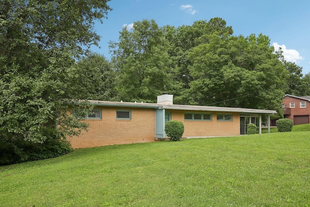 929 Deervale Dr, Nashville, TN 37217 - back of house featuring a lawn, a chimney, and brick siding