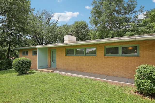 929 Deervale Dr, Nashville, TN 37217 - view of front of house with a front lawn, a chimney, and brick siding
