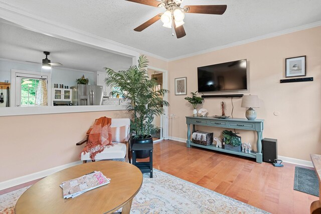 7214 Timberlane Dr, Fairview, TN 37062 - living area with a ceiling fan, wood finished floors, ornamental molding, baseboards, and a textured ceiling