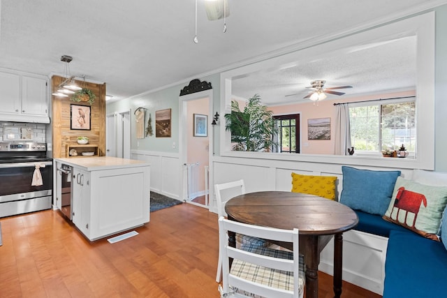7214 Timberlane Dr, Fairview, TN 37062 - kitchen with stainless steel appliances, ceiling fan, white cabinetry, light wood-style flooring, and light countertops