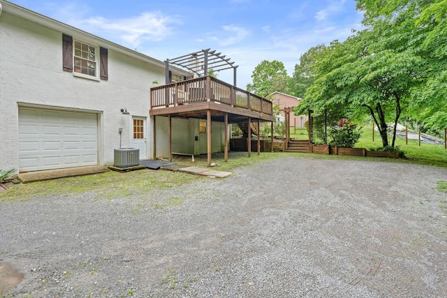 7214 Timberlane Dr, Fairview, TN 37062 - back of house featuring a deck, gravel driveway, a pergola, cooling unit, and an attached garage