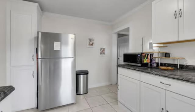 506 Garden St, Mount Pleasant, TN 38474 - kitchen featuring stainless steel appliances, dark stone countertops, white cabinetry, light tile patterned flooring, and crown molding