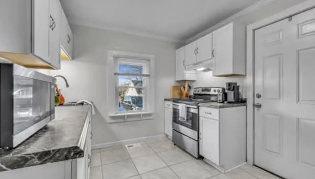 506 Garden St, Mount Pleasant, TN 38474 - kitchen featuring appliances with stainless steel finishes, white cabinets, baseboards, under cabinet range hood, and light tile patterned floors