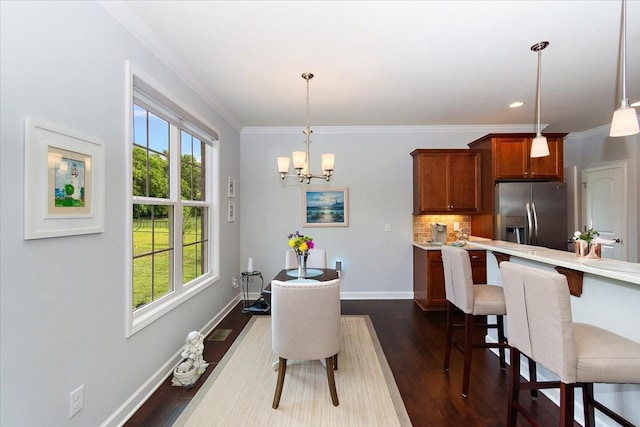 1047 Caballo Trl, Gallatin, TN 37066 - dining space with plenty of natural light, crown molding, a chandelier, baseboards, and dark wood-style floors