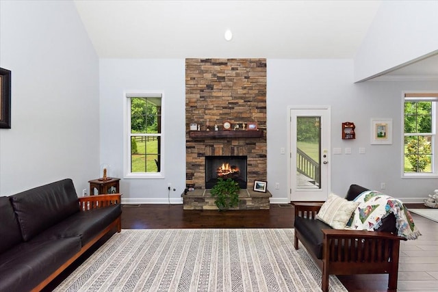 1047 Caballo Trl, Gallatin, TN 37066 - living room with wood finished floors, a stone fireplace, and baseboards