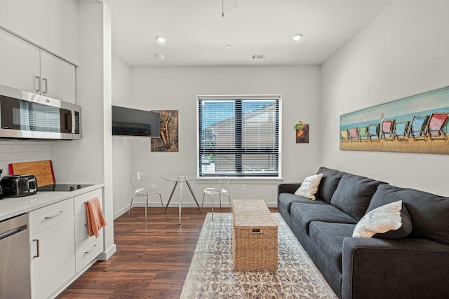 1014 16th Ave S Unit 210, Nashville, TN 37212 - living room featuring dark wood-style floors, baseboards, and recessed lighting