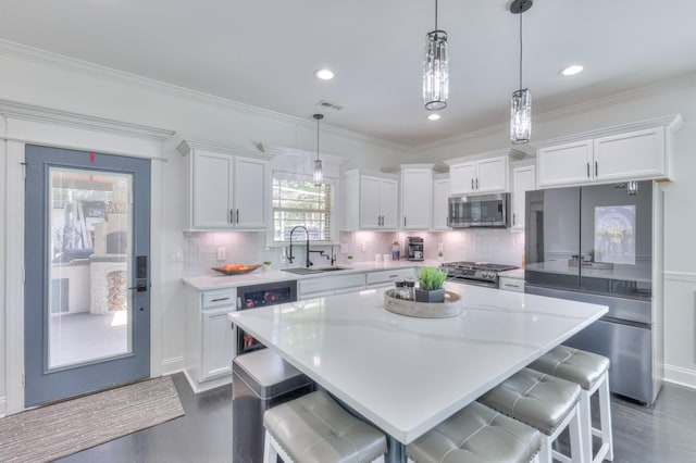 831 W Sagefield Dr, Smyrna, TN 37167 - kitchen featuring stainless steel appliances, a sink, dark wood-style floors, white cabinets, and crown molding