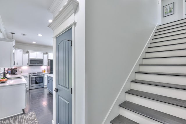 831 W Sagefield Dr, Smyrna, TN 37167 - stairway featuring ornamental molding, wood finished floors, and recessed lighting