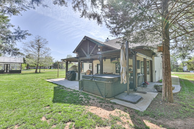 831 W Sagefield Dr, Smyrna, TN 37167 - back of house featuring a hot tub, a patio area, and a yard
