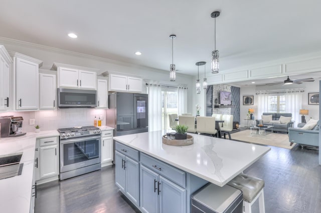 831 W Sagefield Dr, Smyrna, TN 37167 - kitchen with stainless steel appliances, white cabinets, dark wood finished floors, healthy amount of natural light, and recessed lighting