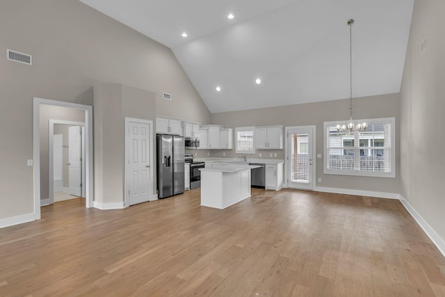 404 Generosity Way, Smyrna, TN 37167 - kitchen with stainless steel appliances, high vaulted ceiling, a chandelier, light countertops, and open floor plan