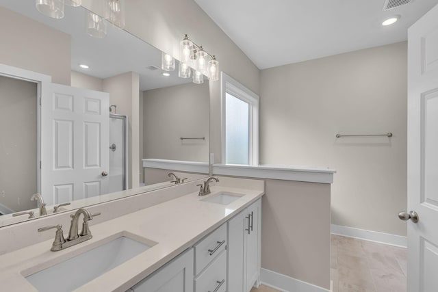 404 Generosity Way, Smyrna, TN 37167 - bathroom with baseboards, double vanity, marble look tiles, a shower, and recessed lighting