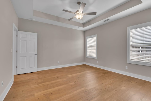 404 Generosity Way, Smyrna, TN 37167 - unfurnished room with a tray ceiling, light wood-style flooring, a ceiling fan, and baseboards