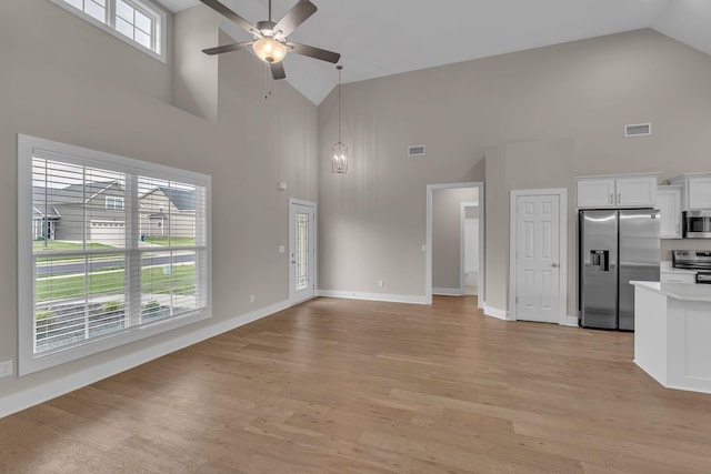 404 Generosity Way, Smyrna, TN 37167 - unfurnished living room featuring high vaulted ceiling, a ceiling fan, light wood-type flooring, and baseboards
