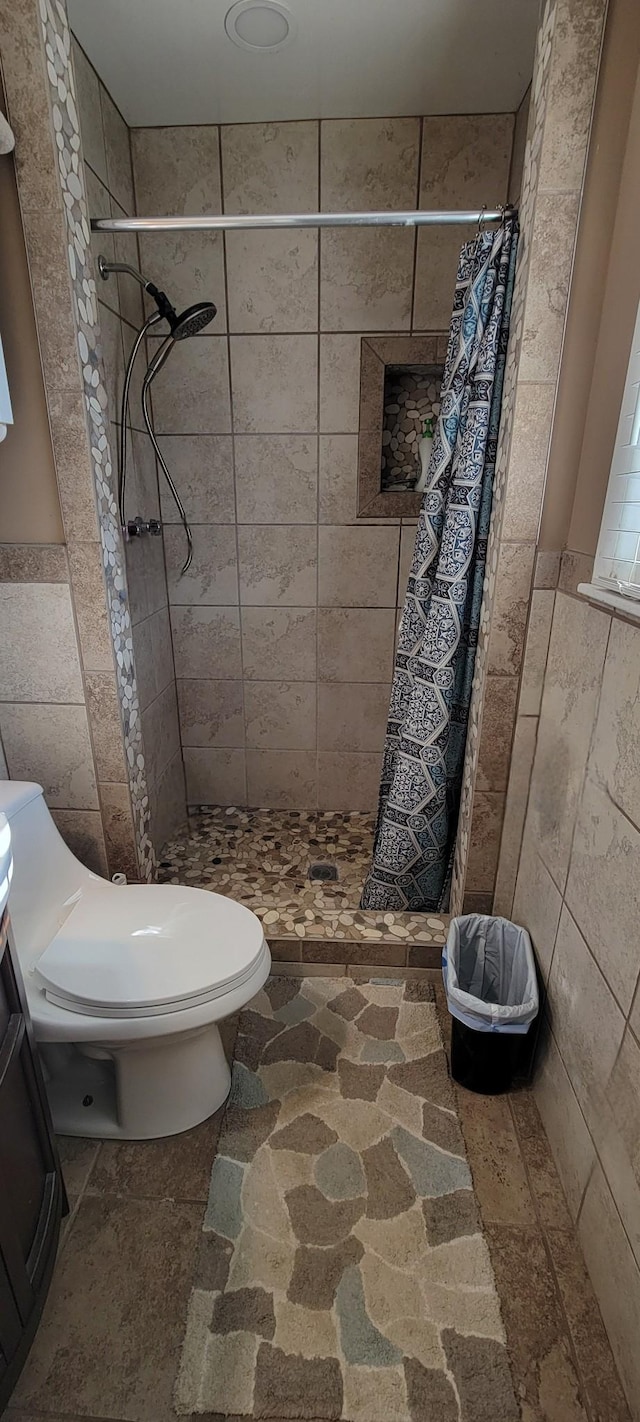 208 Royal Oak Dr, Dickson, TN 37055 - bathroom with tile walls, toilet, a shower stall, wainscoting, and vanity