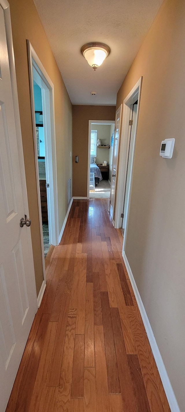 208 Royal Oak Dr, Dickson, TN 37055 - corridor featuring hardwood / wood-style flooring, baseboards, and a textured ceiling