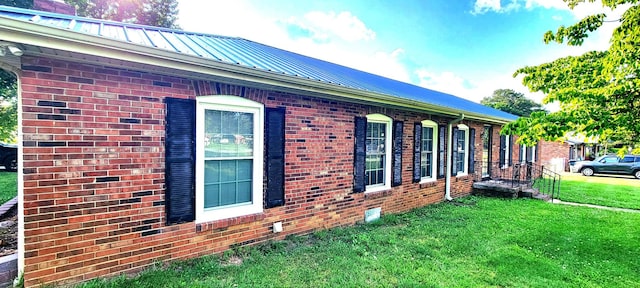 208 Royal Oak Dr, Dickson, TN 37055 - view of side of home featuring a lawn, brick siding, metal roof, and a chimney
