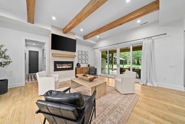 1240 John Windrow Rd, Eagleville, TN 37060 - living area featuring a glass covered fireplace, beamed ceiling, light wood-style floors, recessed lighting, and baseboards