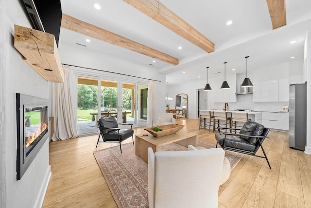 1240 John Windrow Rd, Eagleville, TN 37060 - living room featuring beamed ceiling, light wood-style flooring, recessed lighting, and a high end fireplace